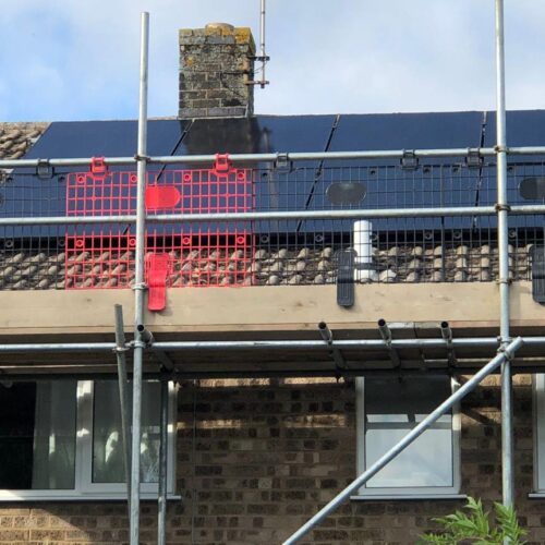 solar panels being installed on a house with scaffolding