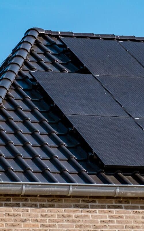 black solar panels on a house rooftop