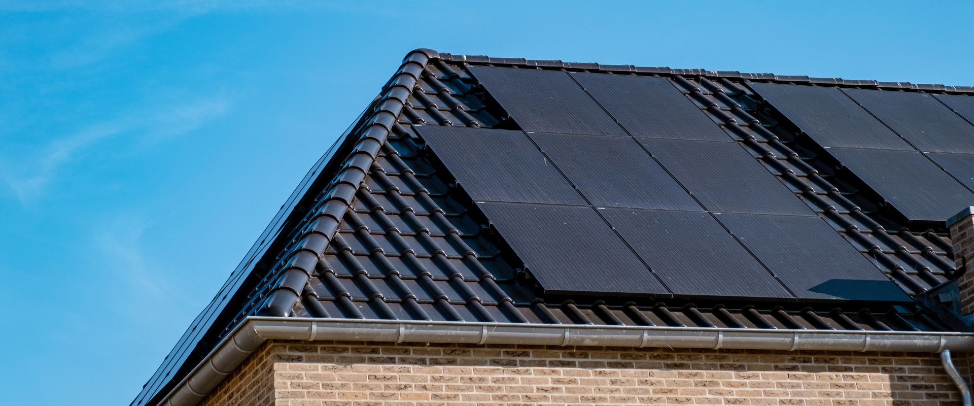 black solar panels on a house rooftop